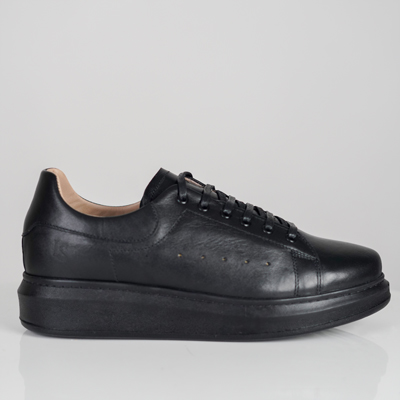 a black shoe on a white surface Alexandera Luxe Noir